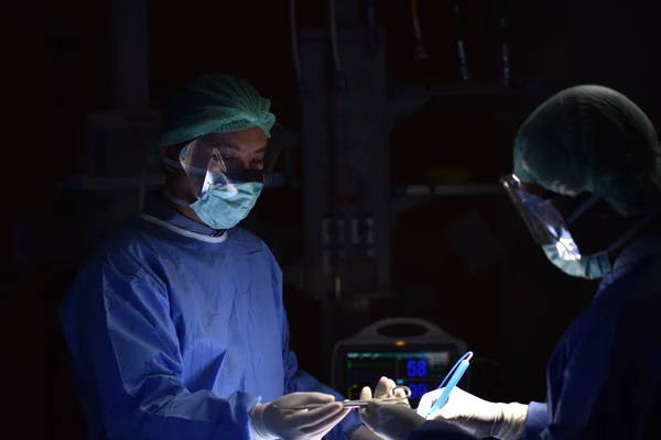 Surgical light in the operating room. Preparation for the beginning of surgical operation with a cut. Team surgeon at work in operating room.Innovative technology in a modern hospital operating room.
