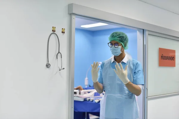 Team surgeon at work in operating room. Surgical light in the operating room. Preparation for the beginning of surgical operation with a cut. The surgeon is performing surgery on the patient.