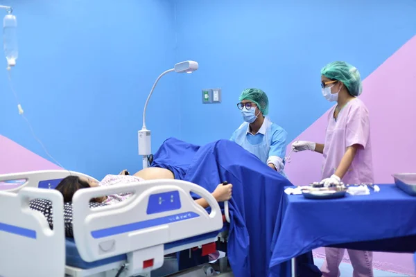 Team surgeon at work in operating room. Surgical light in the operating ...