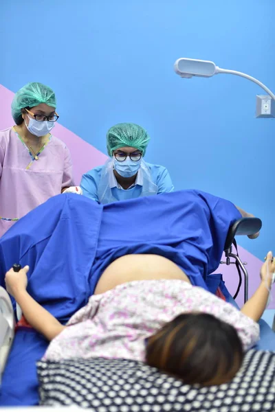 Team surgeon at work in operating room. Surgical light in the operating room. Preparation for the beginning of surgical operation with a cut. The surgeon is performing surgery on the patient.