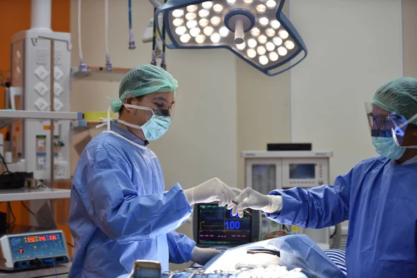 Operating Room.scrub nurse preparing medical instruments for operation.Medical Team Performing Surgical Operation in Modern Operating Room.Equipment and medical devices in hybrid operating room blue filter, Surgical procedures, the operating room