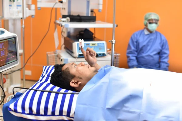 Team surgeon at work in operating room. Surgical light in the operating room. Preparation for the beginning of surgical operation with a cut. The surgeon is performing surgery on the patient.