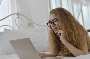 Genç Seksi güzel ve mutlu kadın portresi ben dizüstü kullanma ve yalan bikini. Güzellik kadını çekici ile gülümseme ve sağlık cilt ve saç, tatlı bir gülümsemeyle kadınla güzel bir şey göstermek. 