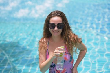 Güzel kız plajda tatlı mayo ile. Parlak bir gün akşamı. Sahilde mayo giymiş seksi genç bayan. Bikinili güzel zarif yanık tenli kadın portresi.