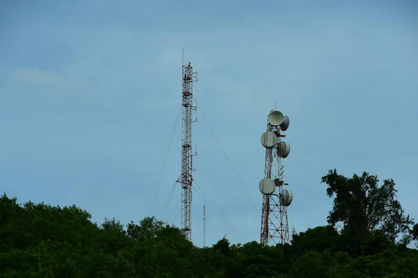 Cell phone atenna Satellite higth above tower.Telephone tower, communication tower antenna with blue sky and clouds.