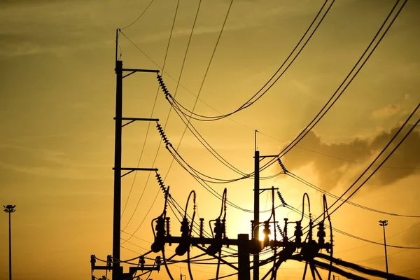 High-power transmission towers with beautiful skies are golden in the pre-dark days.