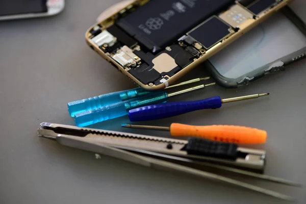smartphone, Repairing mobile phones and tablets by skilled technicians.Experienced testers and check mobile phones. Before and After Repair Tools and equipment for repairing and unpacking mobile phones.technician repairing broken mobile.