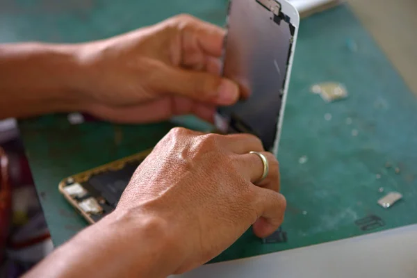 Man repair broken mobile phone