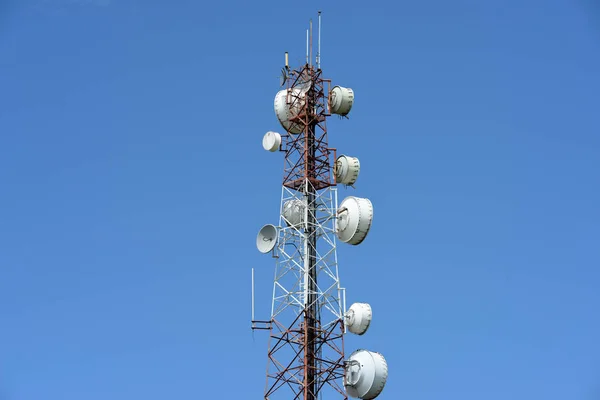 Microwave system.Wireless Communication Antenna With bright sky.Telecommunication tower with antennas with blue sky.