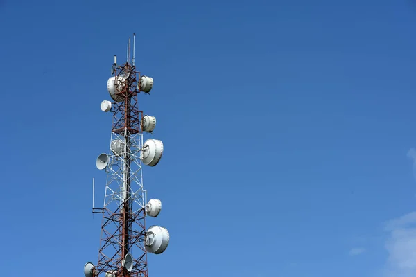 Microwave system.Wireless Communication Antenna With bright sky.Telecommunication tower with antennas with blue sky.