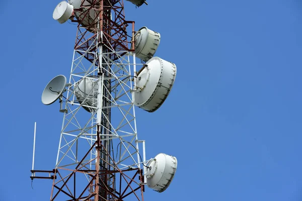 Wireless Communication Antenna With bright sky.Telecommunication tower with antennas with blue sky.