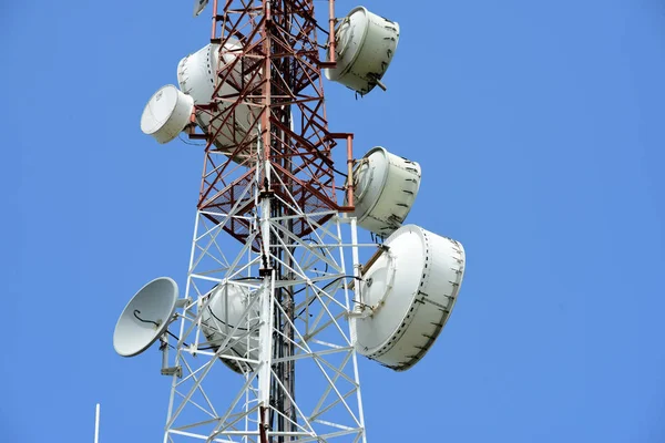 Microwave system.Wireless Communication Antenna With bright sky.Telecommunication tower with antennas with blue sky.