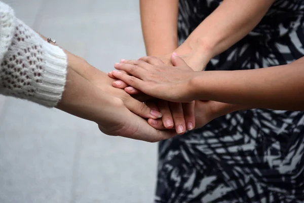 Girl friends is holding hands on each other