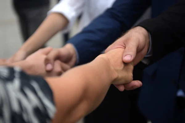 Successful business team is hand shaking each other