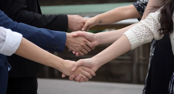 Successful business team is hand shaking each other