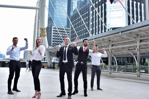 Şehir merkezinde poz veren bir grup iş adamı