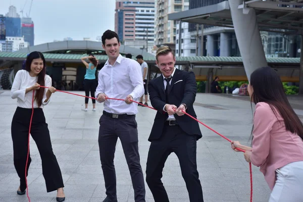 Business team with rope in city downtown