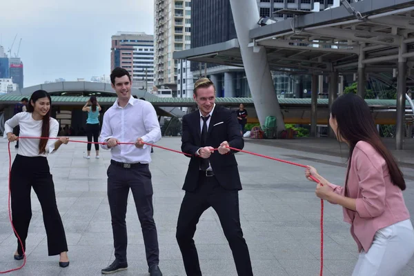 Business team with rope in city downtown