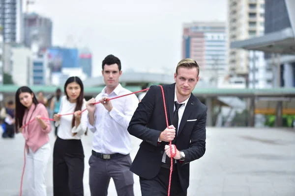 Business team with rope in city downtown