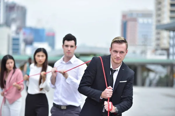 Business team with rope in city downtown