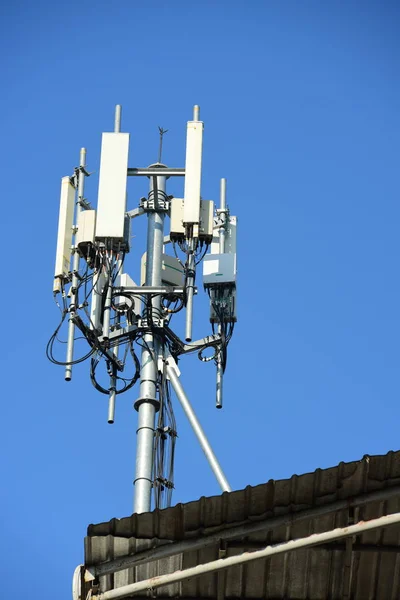 Wireless Communication Antenna With bright sky.Telecommunication tower with antennas with blue and golden sky.