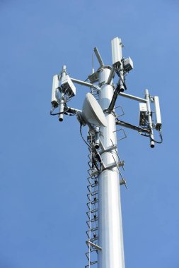 Kablosuz iletişim anteni ile parlak gökyüzü. Telekomünikasyon kule mavi gökyüzü ile antenler ile.
