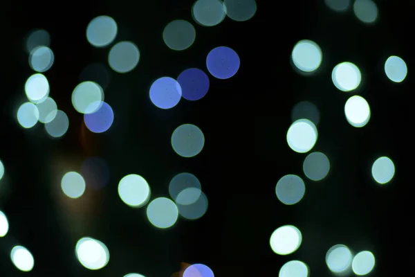 abstract blurred of blue and silver glittering shine bulbs lights background:blur of Christmas wallpaper decorations concept.christmas light night,abstract circular bokeh background.bokeh lights .