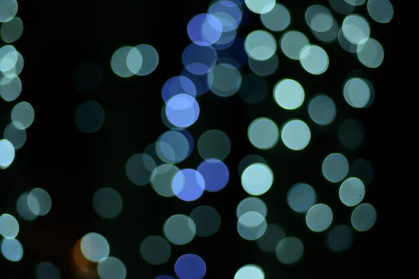 abstract blurred of blue and silver glittering shine bulbs lights background:blur of Christmas wallpaper decorations concept.christmas light night,abstract circular bokeh background.bokeh lights .