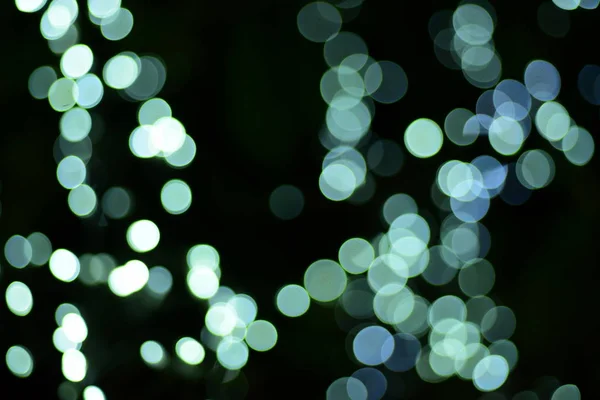 abstract blurred of blue and silver glittering shine bulbs lights background:blur of Christmas wallpaper decorations concept.christmas light night,abstract circular bokeh background.bokeh lights .