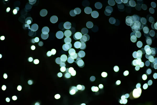 abstract blurred of blue and silver glittering shine bulbs lights background:blur of Christmas wallpaper decorations concept.christmas light night,abstract circular bokeh background.bokeh lights.