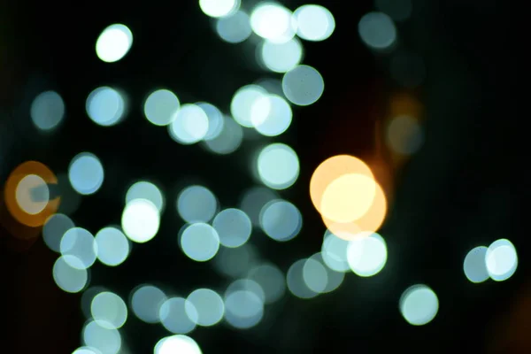 abstract blurred of blue and silver glittering shine bulbs lights background:blur of Christmas wallpaper decorations concept.christmas light night,abstract circular bokeh background.bokeh lights.