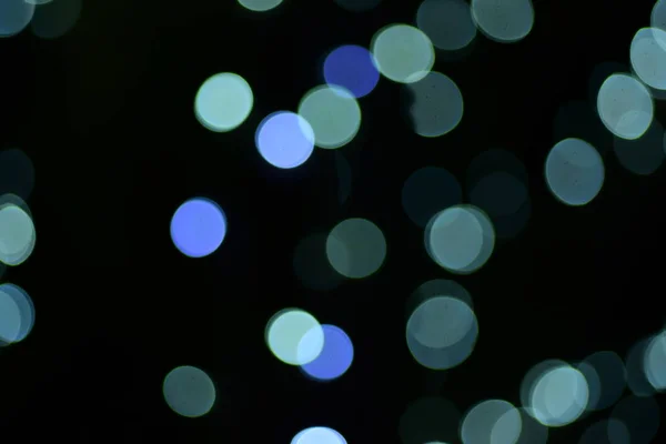 abstract blurred of blue and silver glittering shine bulbs lights background:blur of Christmas wallpaper decorations concept.christmas light night,abstract circular bokeh background