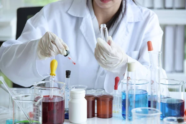 Young women scientists are experimenting with science at the lab.Asian scientist holding a test tube in a laboratory