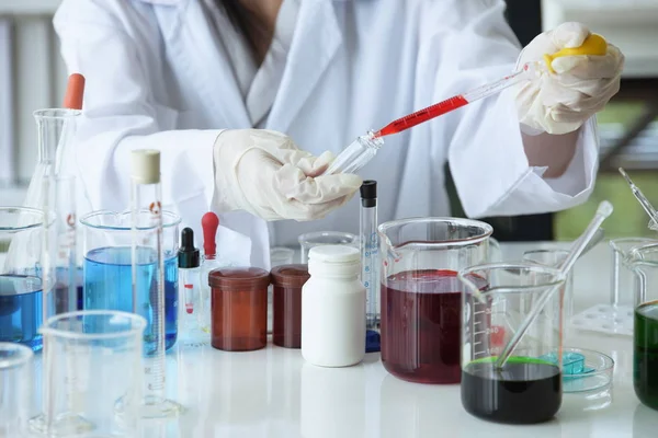 Young women scientists are experimenting with science at the lab.Asian scientist holding a test tube in a laboratory