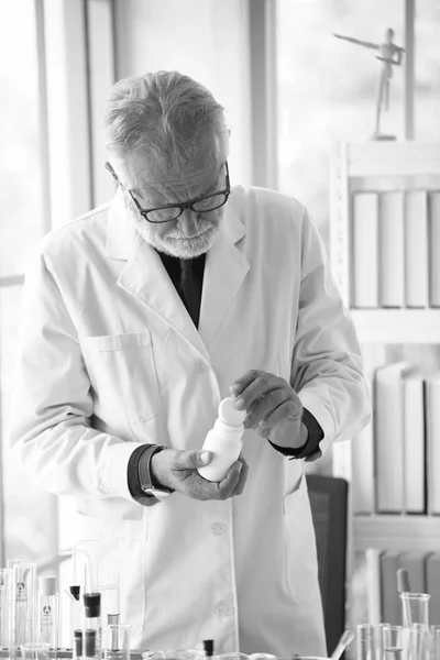 Old male scientist working in laboratory