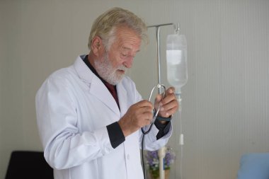 Steteskoplu ve üniformalı yaşlı bir doktor. 