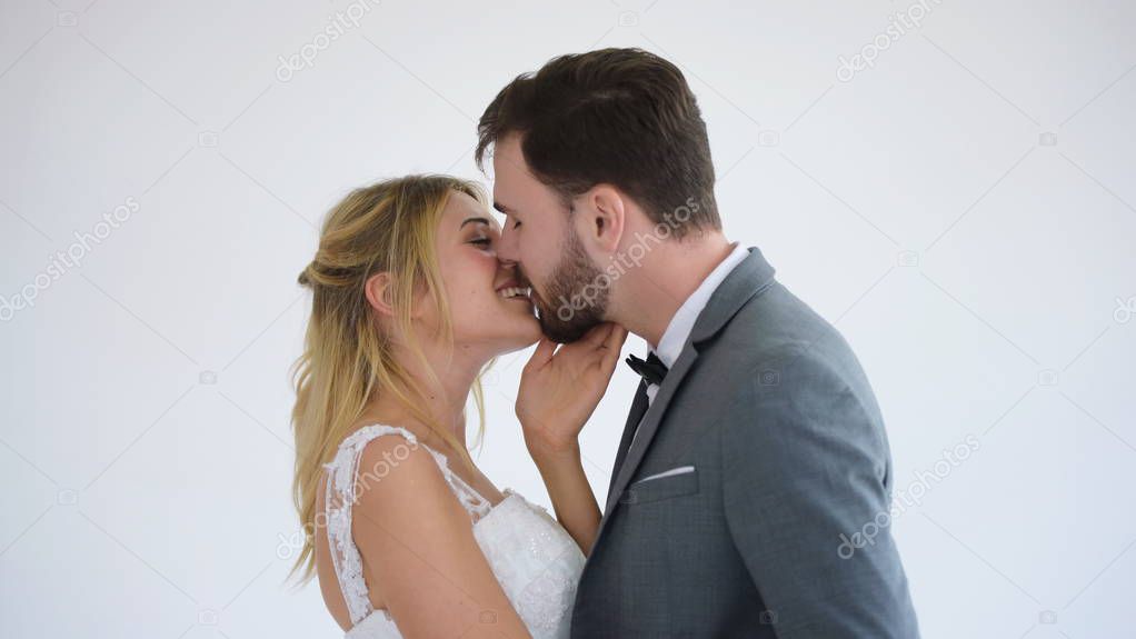 happy wedding couple posing at studio