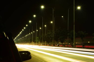 Aydınlatma ve sokak aydınlatma, araba ışıklar gece ulus için havaalanına yakın bir yolda. Arka plan görüntüsü olarak kullanın.