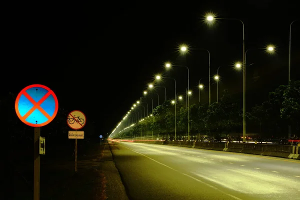 Lighting and street lighting, car lights at night on a road close to the airport for the nation. Use as background image.