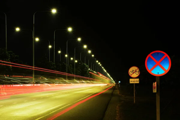 Lighting and street lighting, car lights at night on a road close to the airport for the nation. Use as background image.