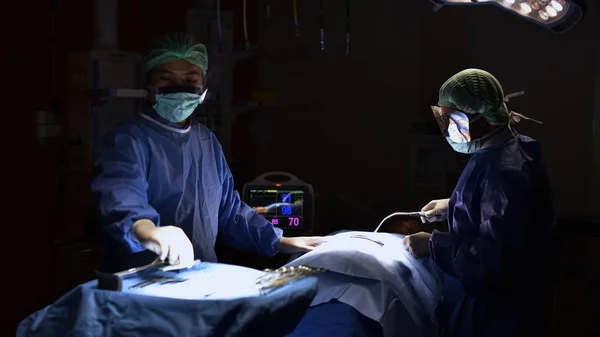 Surgical light in the operating room. Preparation for the beginning of surgical operation with a cut. Team surgeon at work in operating technology in a modern hospital operating room.