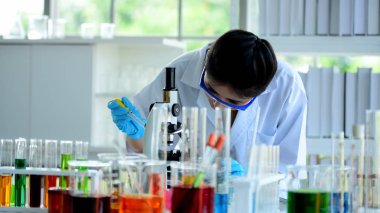 Genç bilim adamları laboratuarda test tüpü tutan Asya bilim adamı, bilim ile çalışıyoruz. Bilim adamları bilim laboratuvarlarında çalışıyoruz. 