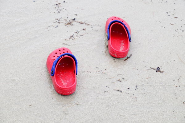 shoes on wet sandy beach surface