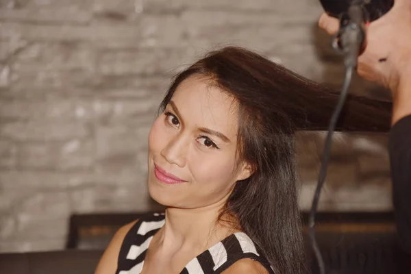 Asian woman doing hairstyle
