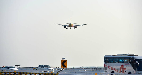 The plane is flying into the airport to land at Suvarnabhumi Airport. Thailand. The plane is tilting to turn into the airport. Landing commercial airplane.