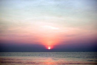 Yükselen güneş manzarası ve plaj. Güzel altın sarısı gökyüzü ve plaj, plaj ve şezlong güneşlenme görünümü yükseliyor. Güzel altın sarıgökyüzü ve güneş