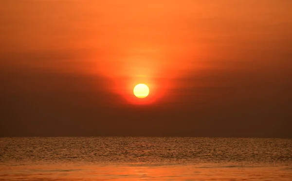 Early morning beach views With a lounge chair When the sun is rising Beautiful golden yellow sky and sun.The view of the beach, the beach and the sun loungers are rising.