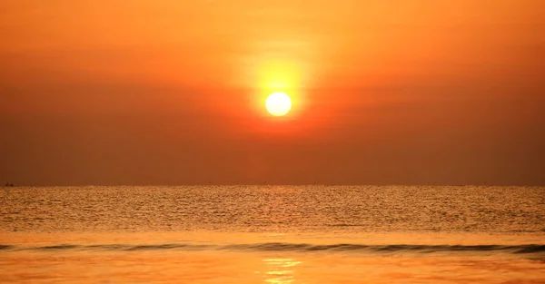 Early morning beach views With a lounge chair When the sun is rising Beautiful golden yellow sky and sun.The view of the beach, the beach and the sun loungers are rising.