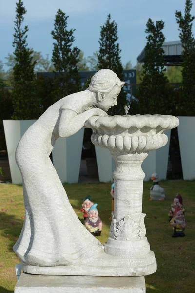 white sculpture in a park at daytime