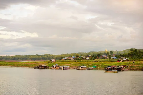 Village with floating houses and sailing boats, Thailand.